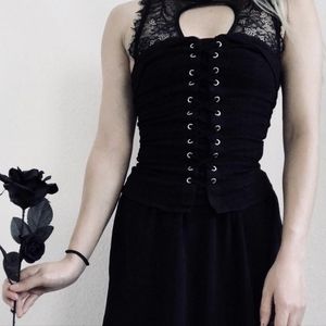 Black corset top with lace up front detail. Strapless